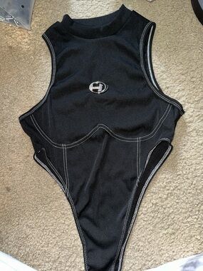Black Ribbed High-Cut Bodysuit with Silver Emblem